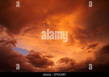 Dramatic late afternoon clouds, illuminated by the setting sun during a thunderstorm event. Stock Photo