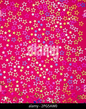 Star background - Colorful party confetti with sparkling stars. Rhodamine red color in foamy Stock Photo