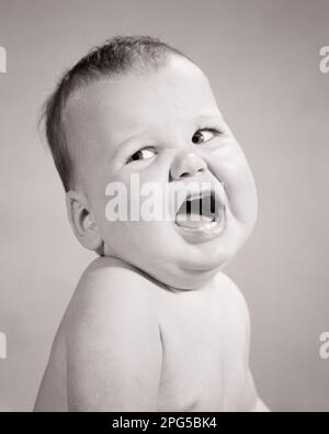 1960s ANGRY BABY BOY LOOKING TO THE SIDE MOUTH OPEN WIDE - b23349 HAR001 HARS COMMUNICATION TANTRUM INFANT WORRY LIFESTYLE ANNOYED STUDIO SHOT MOODY COPY SPACE MALES EXPRESSIONS TROUBLED B&W CONCERNED FRUSTRATED SADNESS WIDE YELLING COMPLAINING HEAD AND SHOULDERS LOUD BAWLING MOOD TEMPER GLUM BABY BOY FURIOUS IRRITATED JUVENILES MISERABLE BLACK AND WHITE CAUCASIAN ETHNICITY HAR001 LOOKING TO SIDE OLD FASHIONED Stock Photo