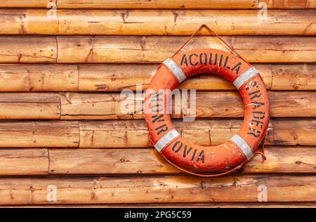 Fairbanks, Alaska, USA - July 27, 2011: Pike's Waterfront lodges. Closeup of historic red lifebuoy fixed on brown wooden wall Stock Photo