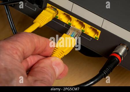 Connecting the device to the Internet using a cable. Close up. Stock Photo