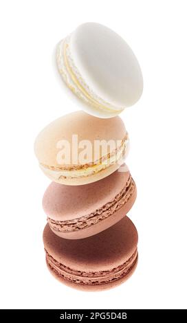 Chocolate and coffee flavored macaroons levitating, vertical isolated on white Stock Photo
