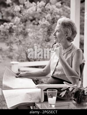 1960s THOUGHTFUL SENIOR WOMAN SITTING OUTDOORS ON PORCH READING MAGAZINE - s16993 HAR001 HARS SATISFACTION ELDER FEMALES RURAL GROWNUP HEALTHINESS HOME LIFE COPY SPACE HALF-LENGTH LADIES PHYSICAL FITNESS PENSIVE PERSONS THOUGHTFUL INSPIRATION GROWN-UP CARING RETIREMENT SERENITY SPIRITUALITY CONFIDENCE EYEGLASSES SENIOR ADULT MIDDLE-AGED B&W SADNESS SENIOR WOMAN FREEDOM DREAMS HAPPINESS OLD AGE MIDDLE-AGED WOMAN WELLNESS OLDSTERS OLDSTER LEISURE CHOICE RECREATION REFLECTIVE THINK PRIDE REFLECTING SMILES ELDERS PONDER PONDERING CONSIDER LOST IN THOUGHT IMAGINATION STYLISH SUPPORT CONTEMPLATIVE Stock Photo