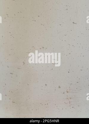 Concrete background of light gray uneven texture with gouges and dents Stock Photo