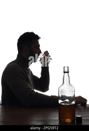 Silhouette of addicted man drinking alcohol on white background Stock Photo