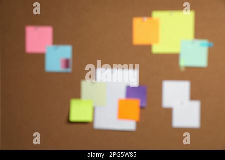 Blurred view of cork board with many colorful notes Stock Photo