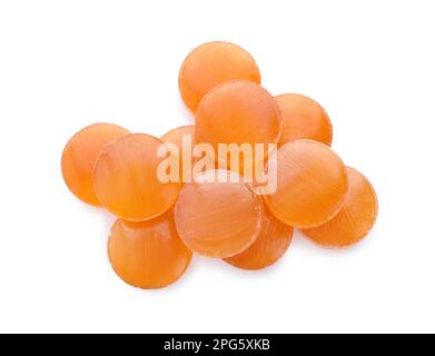 Many orange cough drops on white background, top view Stock Photo