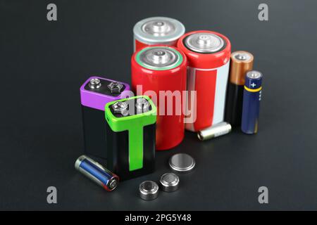 Different types of batteries on black background Stock Photo