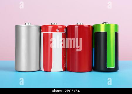 Different new D batteries on color background Stock Photo
