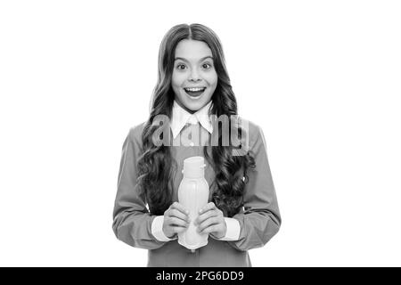 Happy kid hold plastic yellow bottle with liquid dairy food isolated on white, drinkable yogurt Stock Photo