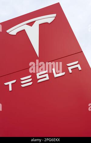 Tesla car brand advertising sign in front of a Tesla car dealership in Magdeburg in Germany Stock Photo