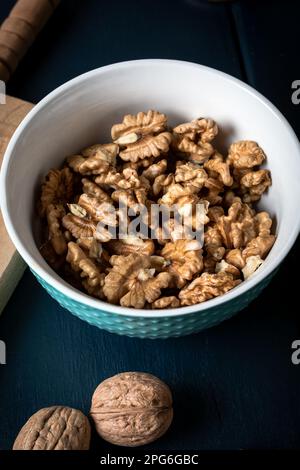 Walnut kernel halves, in a wooden bowl. Walnuts in wooden bowl. Stock Photo