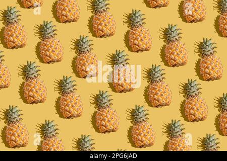 pineapple on a yellow background pattern, pineapple laid out on the background Stock Photo