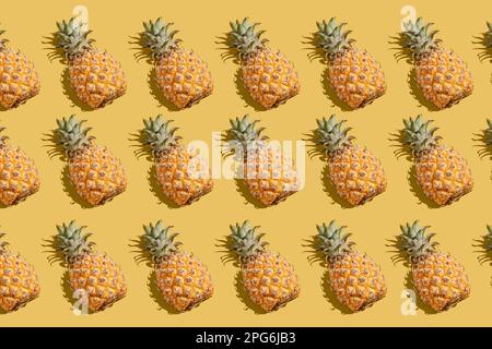 pineapple on a yellow background pattern, pineapple laid out on the background Stock Photo