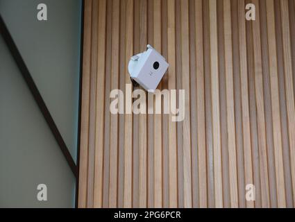 Security  CCTV camera is mounted on the wooden home room wall. CCTV Security Pros: CCTV Security Systems. Stock Photo