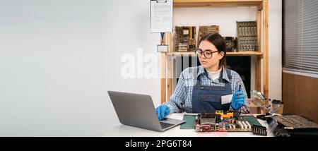 Tech tests electronic equipment in service center. Computer repair. Computer technician working on a personal computer. Copy space. Stock Photo