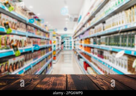 Grocery table background. Blurred supermarket shelves with goods and products. Product demonstration concept. . High quality photo Stock Photo