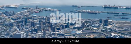 CAPE TOWN, 2023 january 10, aerial cityscape with downtown tall buildings, harbor quays and large rail yard, shot in bright summer light  on january 1 Stock Photo