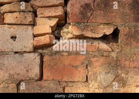 ancient temple wall texture Built with red bricks and plastered with cement. naturally weathered. Stock Photo
