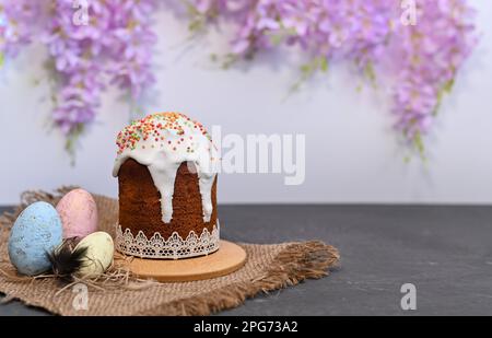 Traditional easter sweet bread with eggs over black table. Easter cake with sugar icing decorated. Side view, copy space. Easter treat, holiday symbol Stock Photo