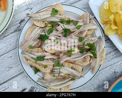 Mediterranean cuisine. Typical Andalusian dish, fresh raw anchovies in vinegar. Stock Photo