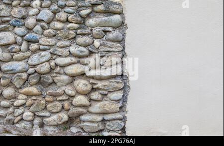River pebble composite wall. Locals materials used as construction material Stock Photo