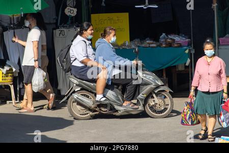 SAMUT PRAKAN, THAILAND, FEB 13 2023,  Two women rides on motorcycle at the marketplace Stock Photo