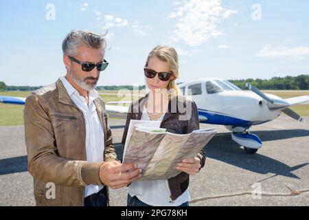 two modern aircraft engineers looking at map Stock Photo