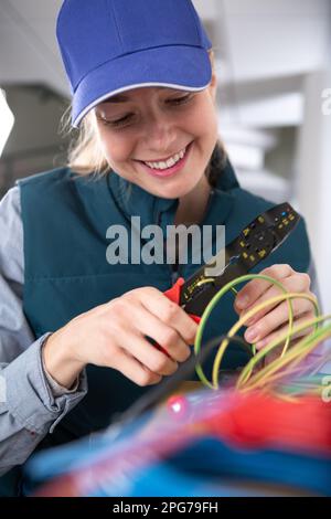 happy technician fixing cable in server room Stock Photo