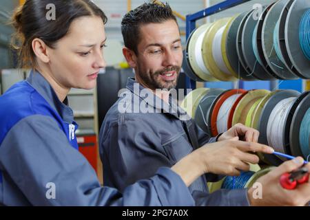 woman and man working in a factory Stock Photo
