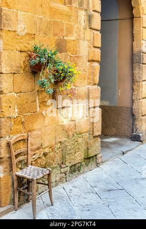 Chair in an alley for tired walkers on their pilgrimage Stock Photo - Alamy