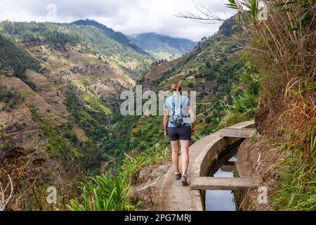 Madeira, Portugal - September 14, 2022: Young Woman Hiking Along The Levada Nova Hiking Trail On Madeira Island, Portugal. Stock Photo