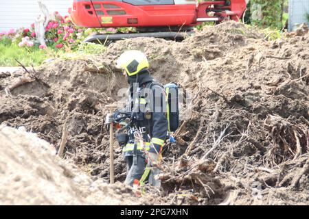 Firefighters must take action if a gas pipe is hit during excavation work at Park de IJsselhoeve in Nieuwerkerk aan den IJssel the Netherlands Stock Photo