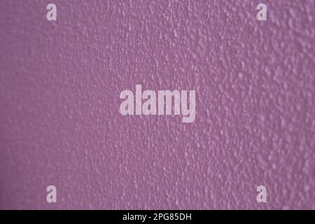 texture of wall painted with violet colored stippled wallpaper Stock Photo