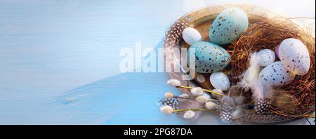 Easter holiday decoration on blue wooden background; sunny Easter morning Stock Photo