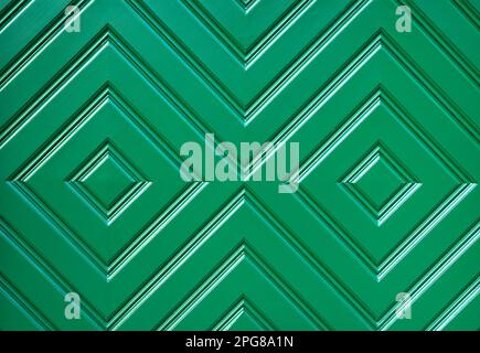 Closeup of the green wooden door with geometrical pattern, useful as background Stock Photo