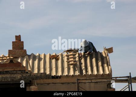 Construction workers do dangerous work on high roofs. But don't focus on self-defense. Stock Photo