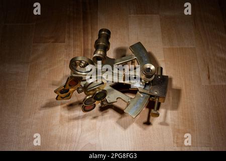 old sextant, spyglass, circle and compass lying on wooden table Stock Photo