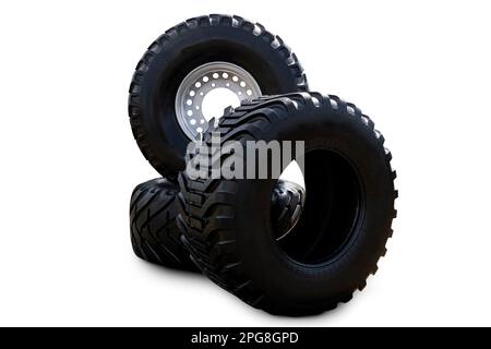 Isolated on white new truck wheel on hub with black shine tire. New clean tractor truck wheel tire. Wheel mud tire on rim on rear axle. Stock Photo