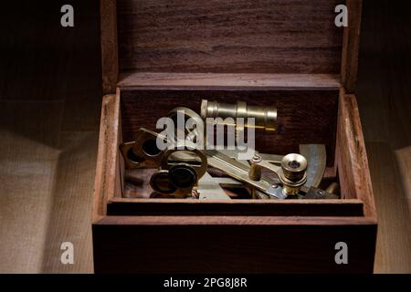 old sextant, spyglass, circle and compass lying on wooden table Stock Photo