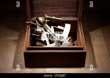 old sextant, spyglass, circle and compass lying on wooden table Stock Photo