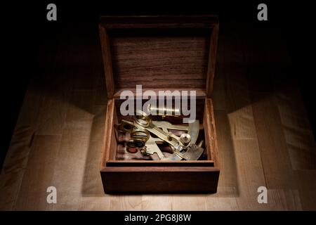old sextant, spyglass, circle and compass lying on wooden table Stock Photo