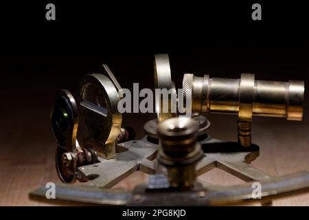 old sextant, spyglass, circle and compass lying on wooden table Stock Photo