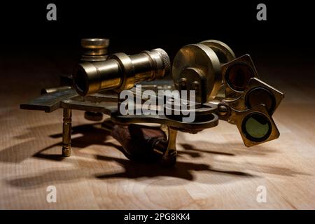 old sextant, spyglass, circle and compass lying on wooden table Stock Photo
