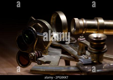 old sextant, spyglass, circle and compass lying on wooden table Stock Photo