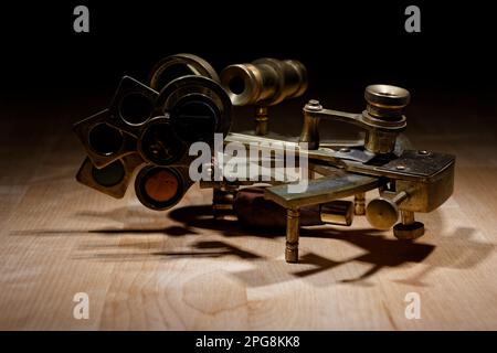 old sextant, spyglass, circle and compass lying on wooden table Stock Photo