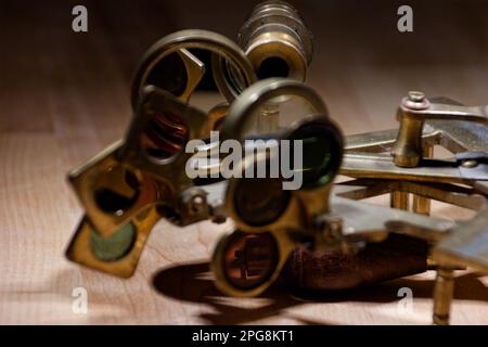 old sextant, spyglass, circle and compass lying on wooden table Stock Photo