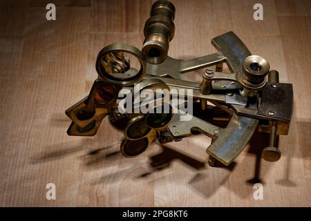 old sextant, spyglass, circle and compass lying on wooden table Stock Photo