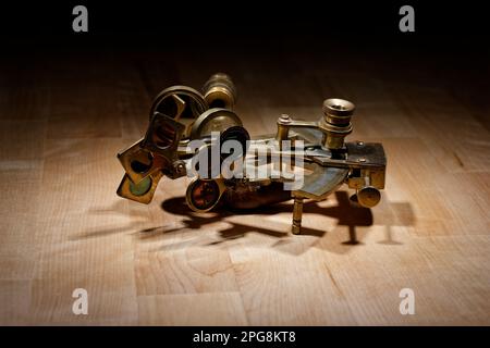 old sextant, spyglass, circle and compass lying on wooden table Stock Photo