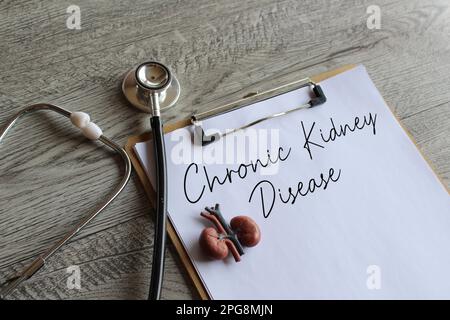 Stethoscope, kidney model and paper clipboard with text Chronic Kidney Disease. Medical and healthcare concept Stock Photo